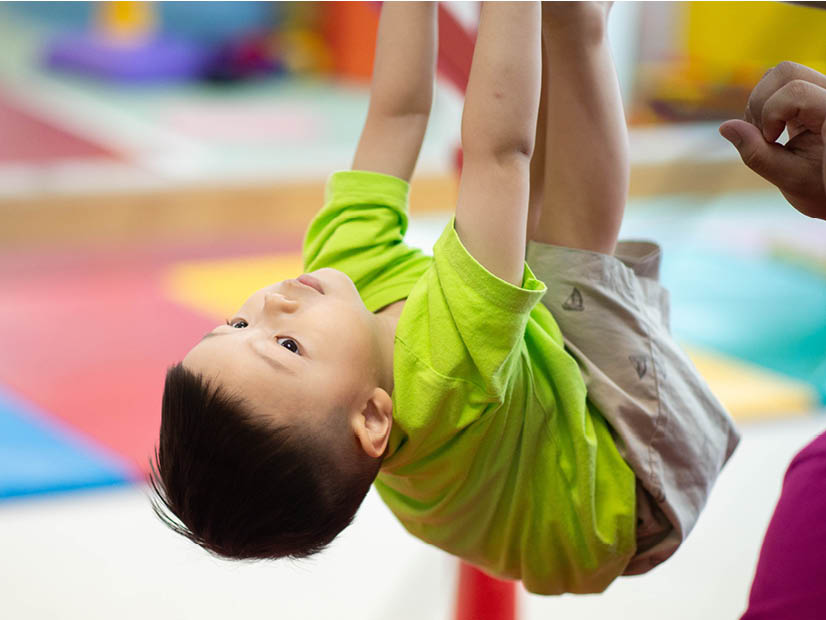 Young toddler on gymnastics equipment